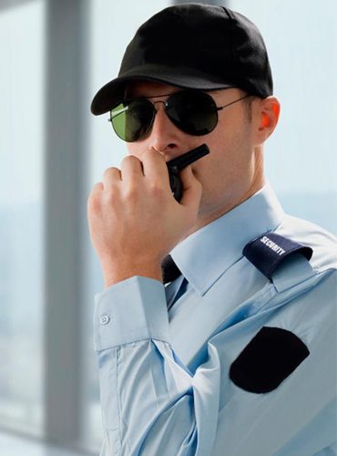 Guard communicating over walkie talkie
